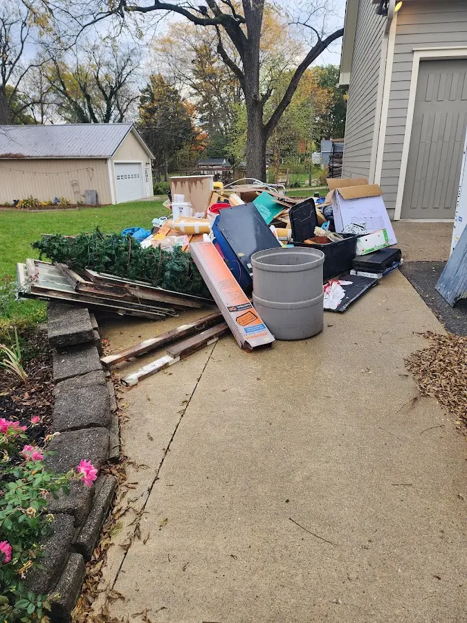 Dumpster being loaded with debris for Estate Cleanout Dumpster Rental in New Carlisle